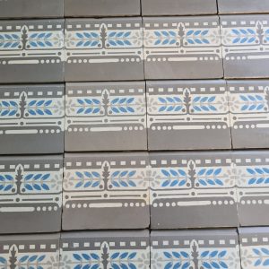 Reclaimed encaustic border tiles in a cool pallete