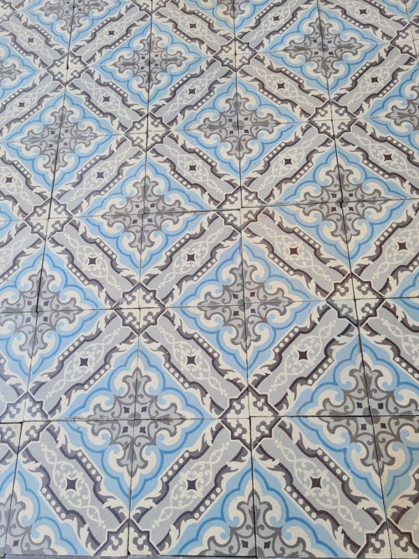 Reclaimed encaustic tiles in shades of grey with ice blue