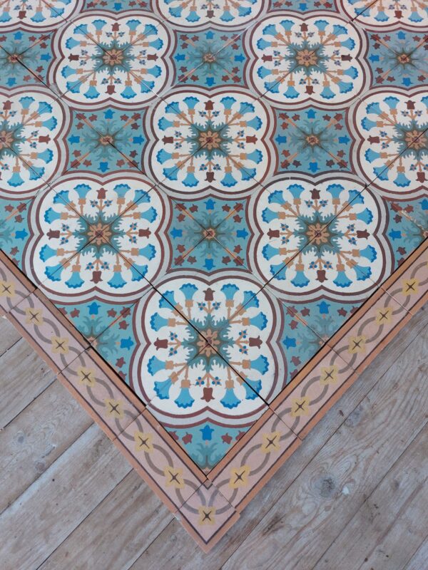 Old encaustic tiles with flower pattern and matching border tiles