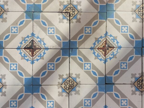 Detail reclaimed encaustic tiles in shades of grey and blue