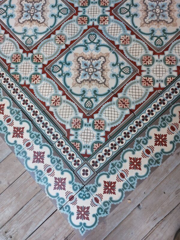 Old encaustic reclaimed tiles with flower pattern and matching borders