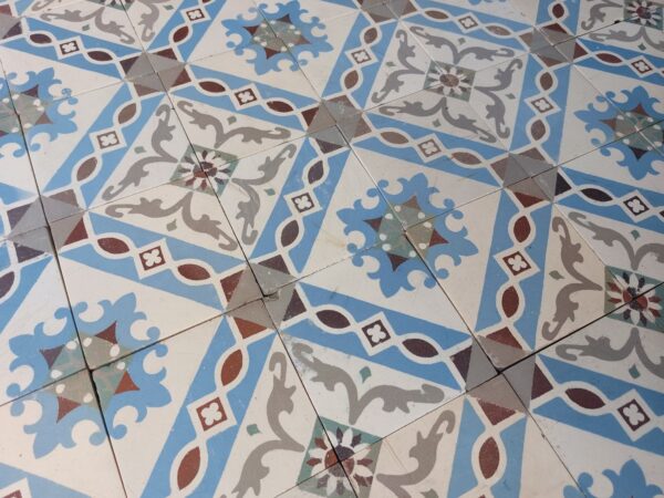 Detail encaustic ceramic tiles in shades of blue and grey