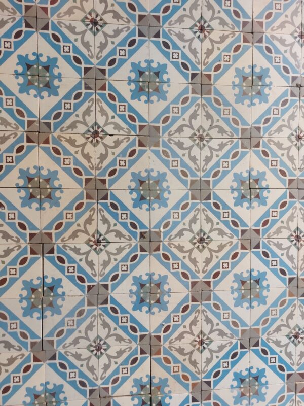 Encaustic ceramic floor tiles with floral motif in shades of blue and grey
