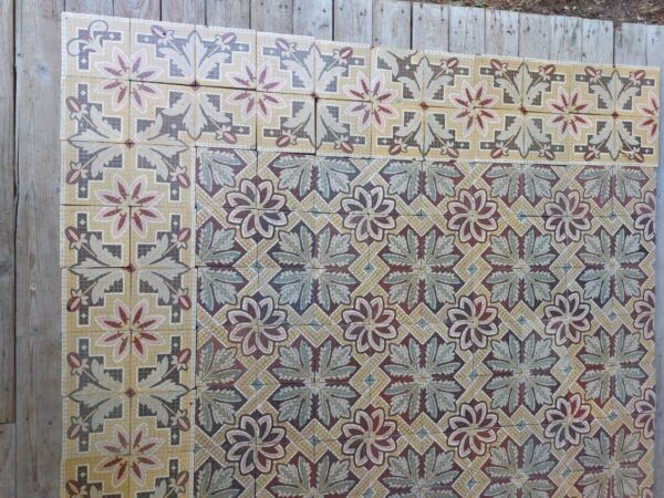 Antique floor tiles with flower motif with a touch of pink, yellow and green and matching borders