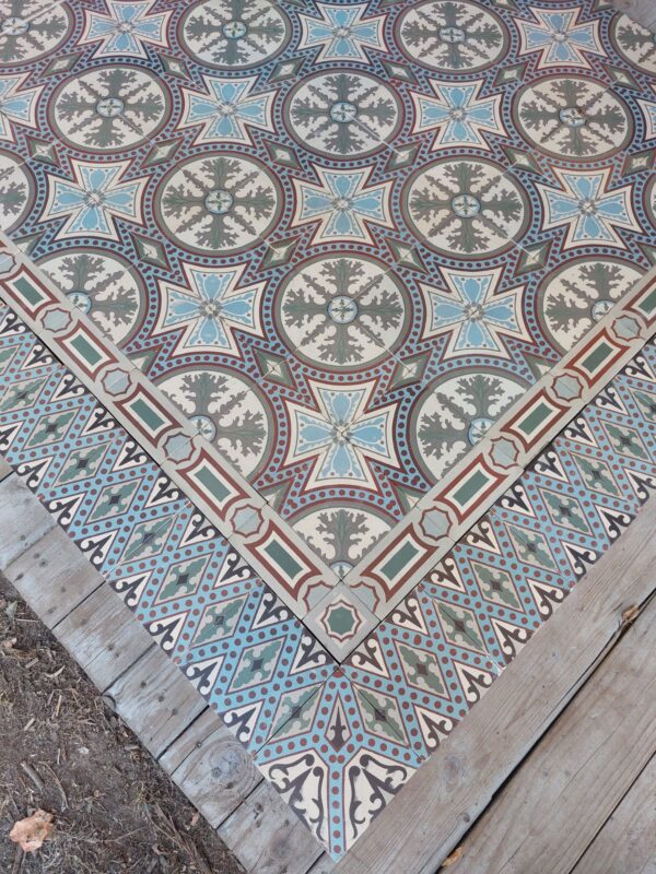 Encaustic reclaimed tiles with a flower pattern alternated with vegetative motif in autumn tones with matching borders