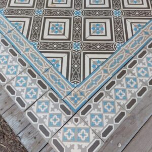 Reclaimed floor tiles with double border in a cool color palette with shades of grey and blue