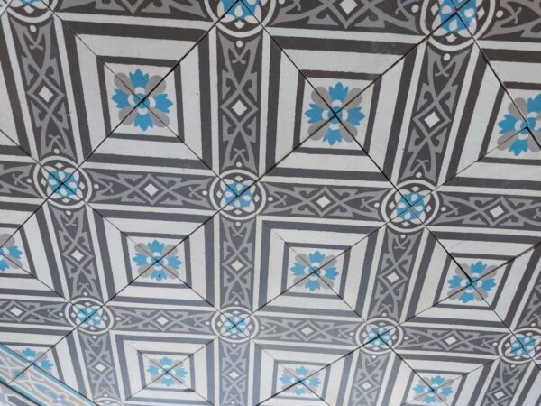 Antique encaustic tiles in a cool color palette with shades of grey and blue