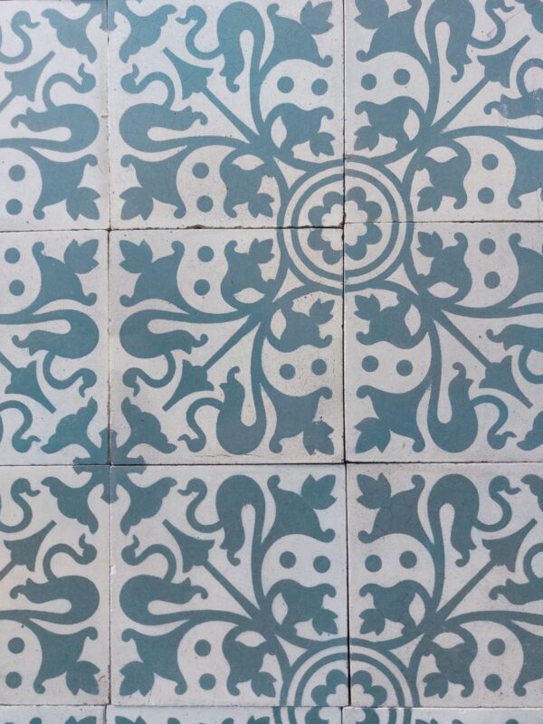 Old tiles in green and white with edge nibbles