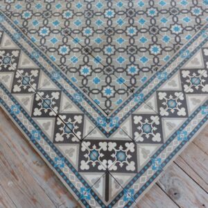 Encaustic reclaimed tiles in shades of grey and blue with original double border tiles