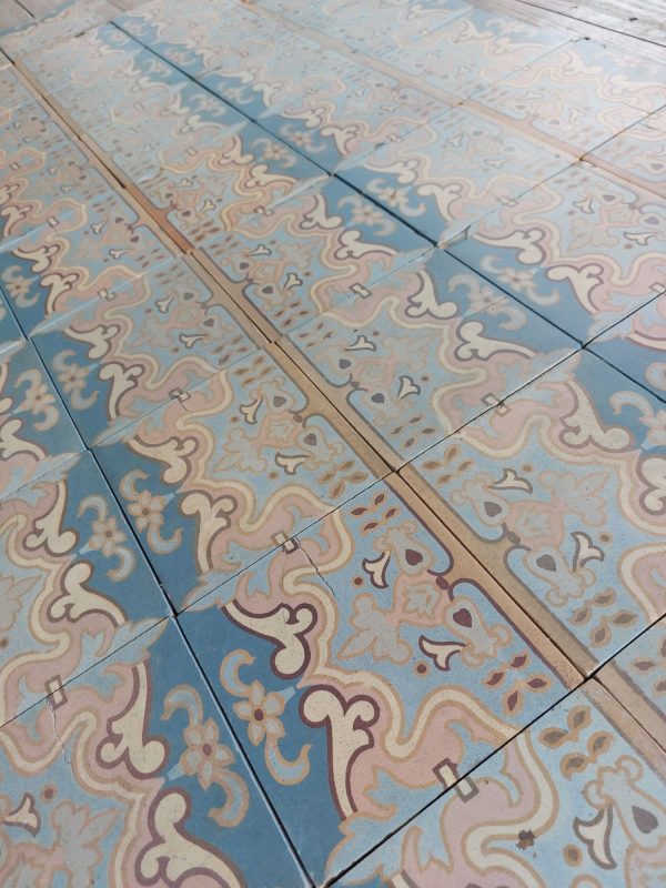 old floor tiles with Art-Nouveau pattern with pink and blue as dominant colors