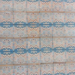 Antique ceramic floor tiles with Art-Nouveau pattern with pink and blue as dominant colors