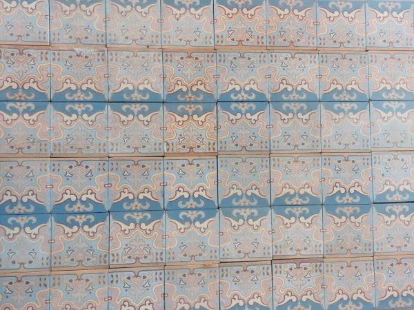Antique ceramic floor tiles with Art-Nouveau pattern with pink and blue as dominant colors