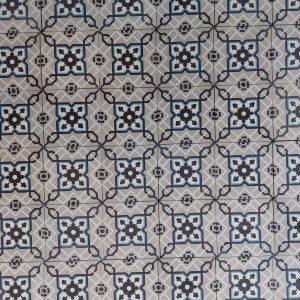 Antique encaustic patterned tiles with a classical design in shades of grey