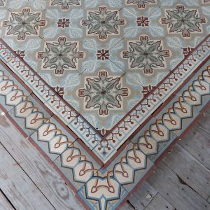 Antique reclaimed tiles with art-nouveau pattern with dominant colors blue and green and matching double borders