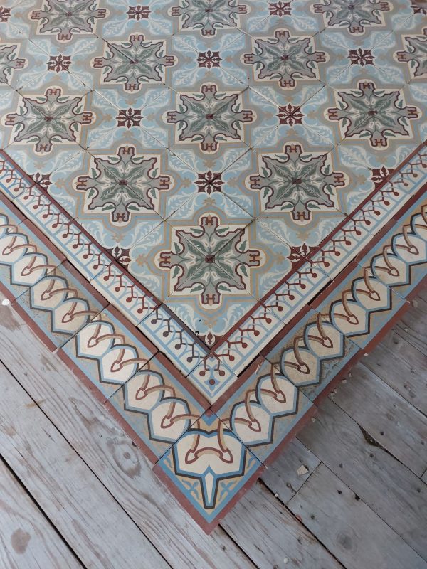 Antique reclaimed tiles with art-nouveau pattern with dominant colors blue and green and matching double borders