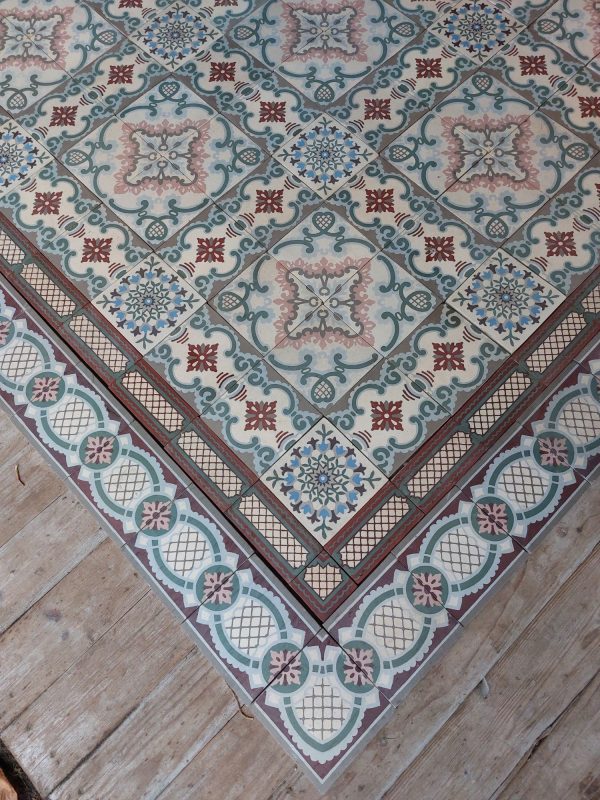 Antique ceramic floor in Art-Nouveau style with floral motif and original double borders