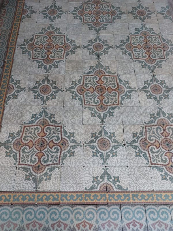 Antique reclaimed encaustic floor in a classical tesselation with matching double border ca 1920