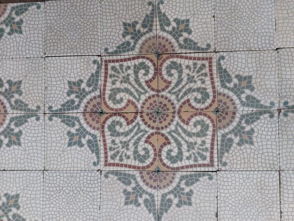 A sixteen tile pattern in green, white, red and orange