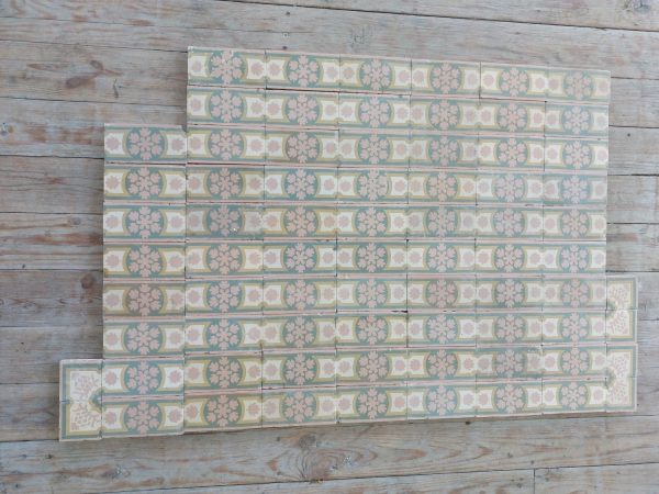 Reclaimed encaustic border tiles with floral motif and pink as dominant color