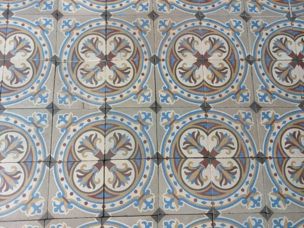 Reclaimed encaustic tiles with a circular motif and a bold flower theme