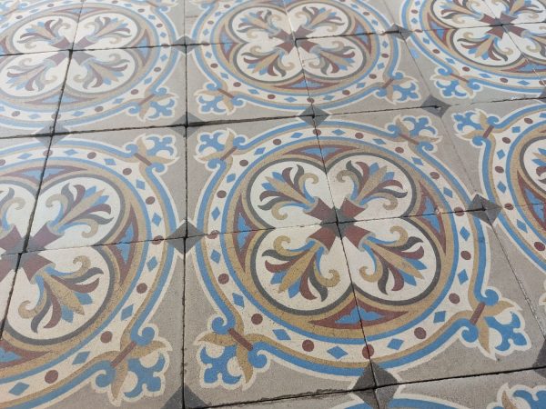 Antique tiles with a circular pattern and a bold flower theme with blue and red as dominant colors