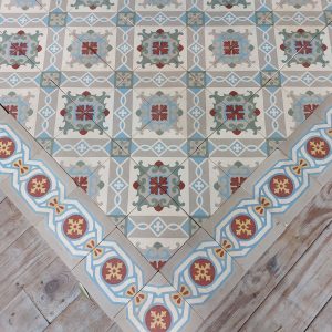 Encaustic reclaimed tiles in a cool color palette with dominante colors blue and grey and single border