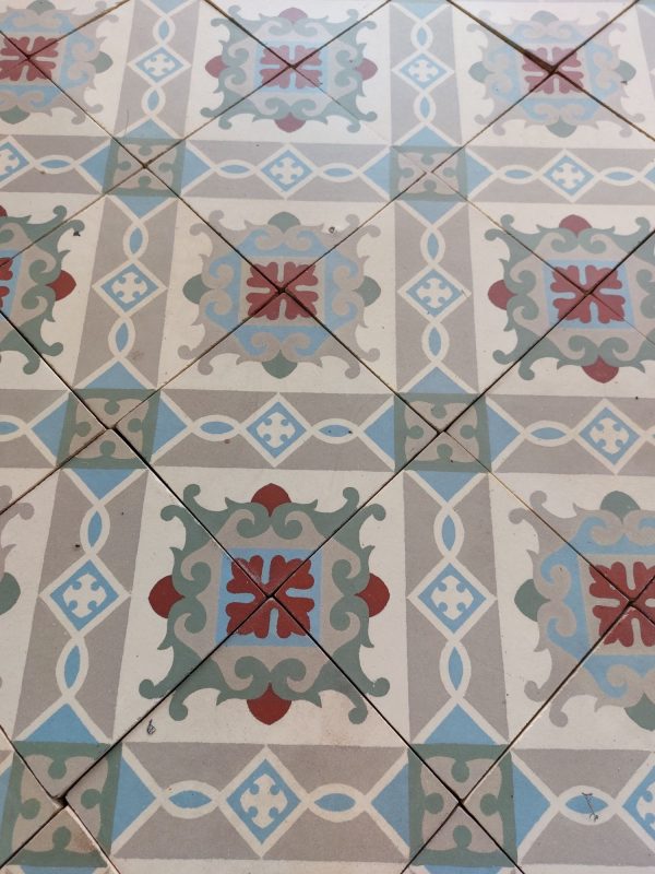Encaustic reclaimed floor with geometrical and floral pattern