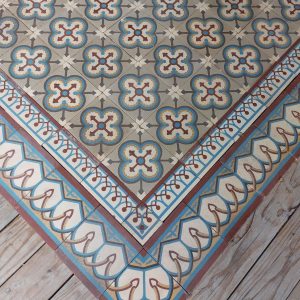 Reclaimed encaustic tiles with geometric pattern in a cool color palette of greys and blue