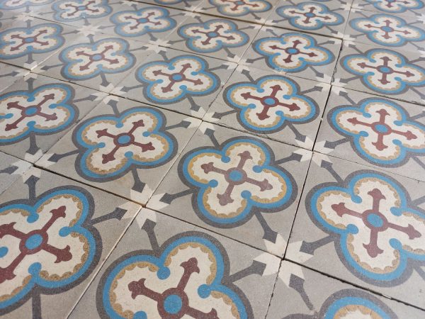 Antique victorian tiles with geometric pattern and dominant colors blue, grey and red