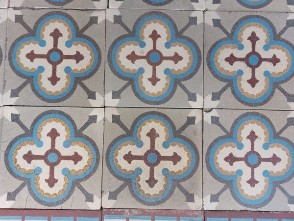 Reclaimed victorian tiles with geometric pattern and dominant colors blue, grey and red
