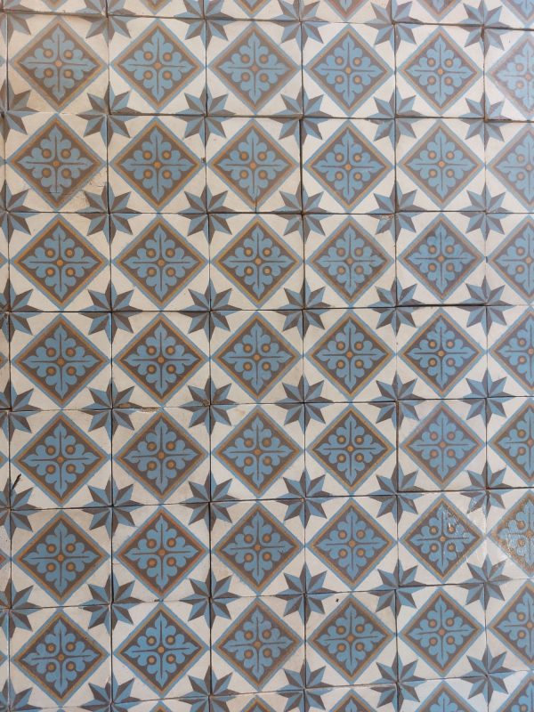 Encausted hand made antique tiles in a cool color palette with blue, white and gold as dominant colors