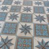 Reclaimed floor tiles in a cool color palette with blue, white and gold as dominant colors