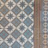 Reclaimed floor tiles in a cool color palette and original double border ca 1895