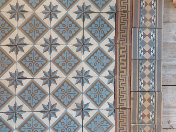 Reclaimed floor tiles in a cool color palette and original double border ca 1895