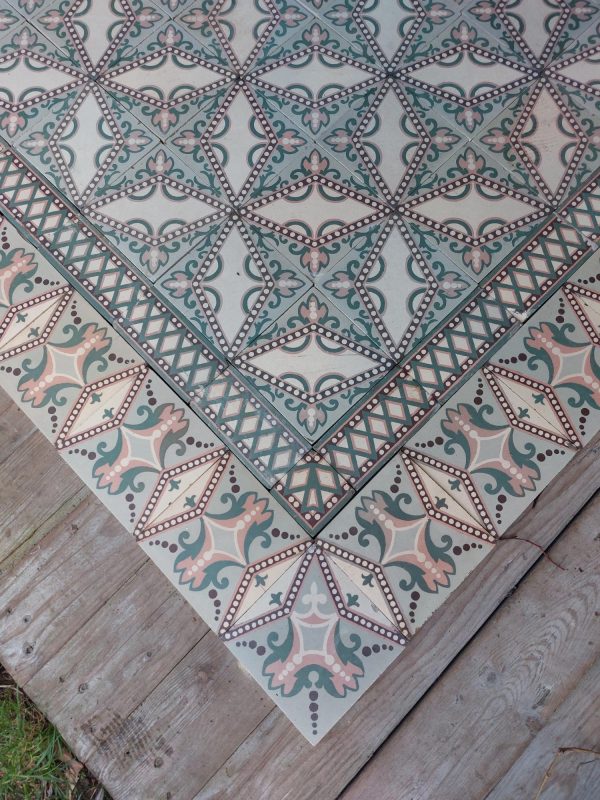 Art-Nouveau encaustic floor with a dotted star pattern in a palette of soft pink and green with original border tiles