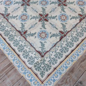 Reclaimed encaustic patterned tiles in a theme of thistle and cornflowers with double border