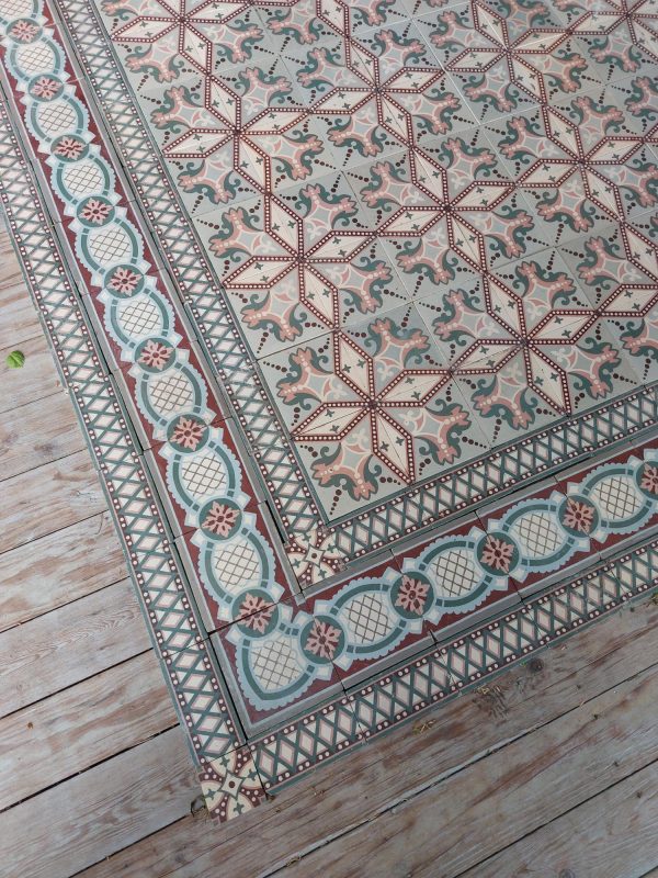 Antique reclaimed floor tiles in a palette of soft green and pik with matching border tiles