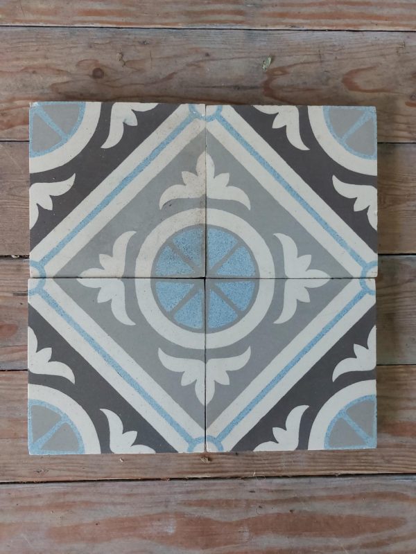 A four tile geometric pattern in different shades of grey with blue