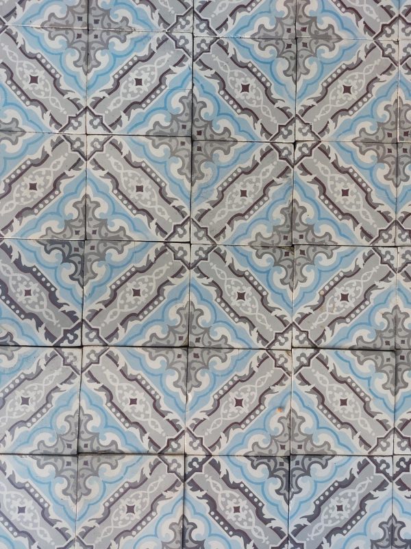 Antique encaustic floor in a cool color palette with grey and blue as dominant colors