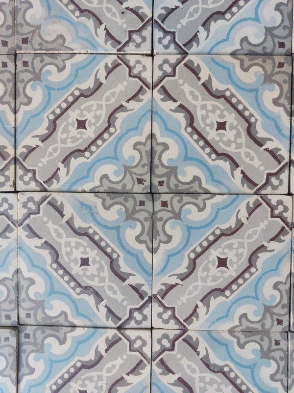 Antique encaustic floor in a cool color palette with grey and blue as dom