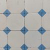 Oude keramische vloertegels met sober patroon met blauw en wit als dominante kleuren