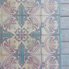 Reclaimed floor with pink and blue as dominant colors with matching border tiles ca 1910
