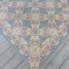 Antique floor tiles with pink and blue as dominant colors with matching border tiles